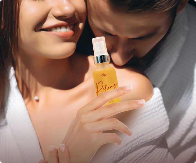 Close-up of a couple with a woman holding a yellow spray bottle.