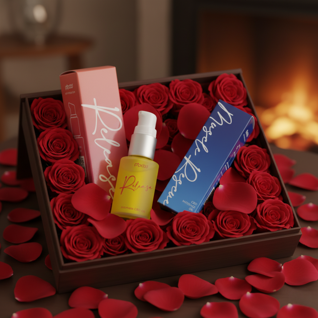 Two CBD oil products are displayed in a wooden box filled with red roses and petals.