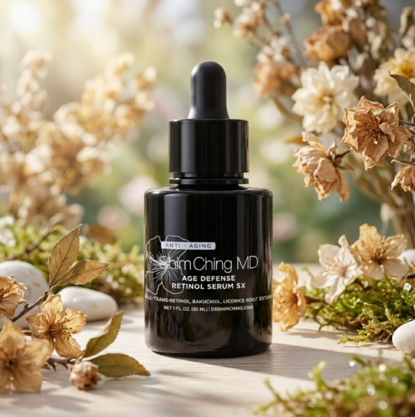 A black bottle of Shim Ching MD Retinol Serum sits among dried flowers, moss, and stones.