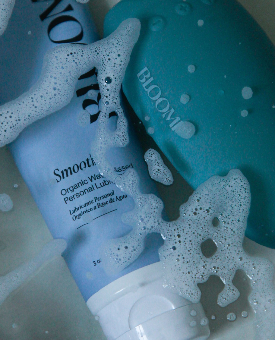 Foamy, clean lifestyle photo of Bloomi Smooth tube and bottle
