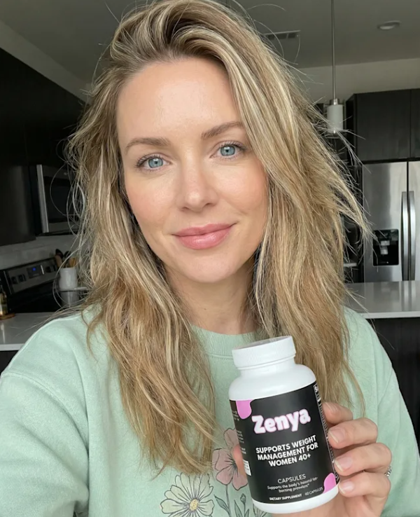 Person holding a Zenya weight management supplement bottle in a kitchen.