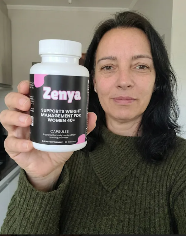 Person holding a bottle of Zenya dietary supplement.
