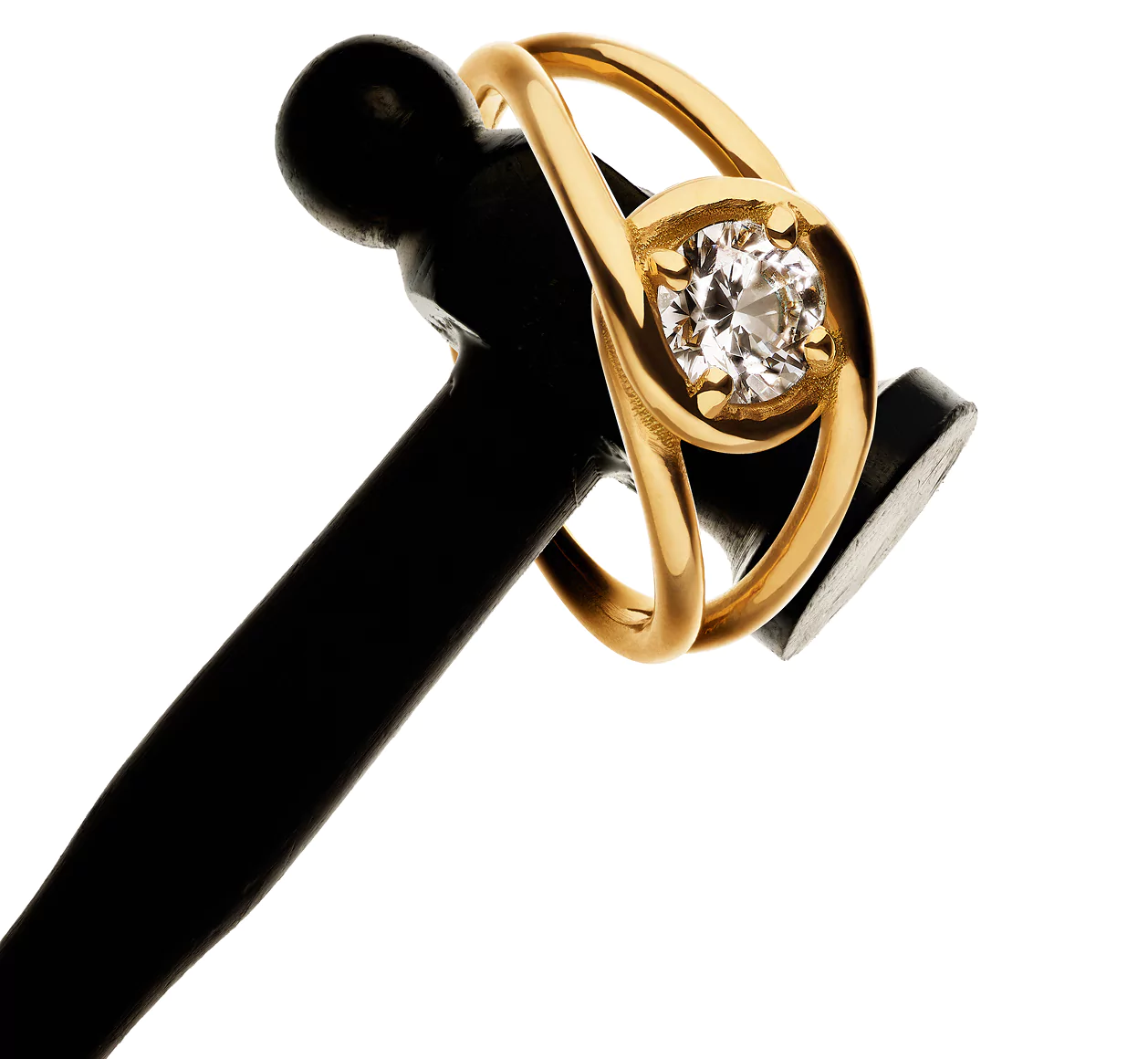 Gold ring with a diamond on a black gavel head.