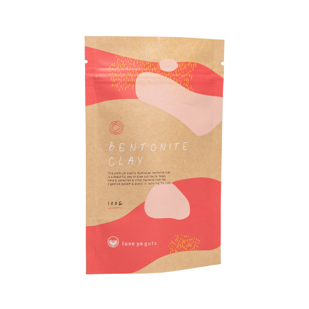 A brown paper pouch of Love Ya Guts Bentonite Clay with abstract pink and red graphics.