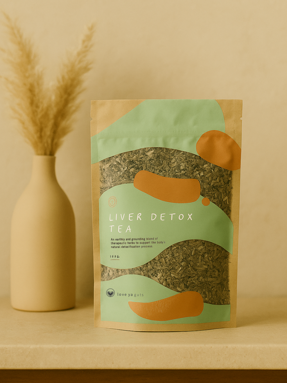 A package of Liver Detox Tea next to a vase with dried grass.