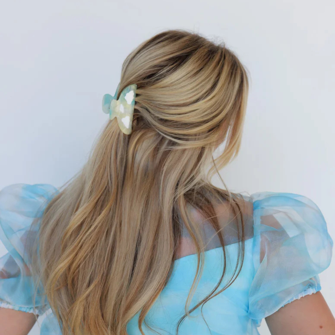 Person with long hair wearing a blue dress, visible from the back.