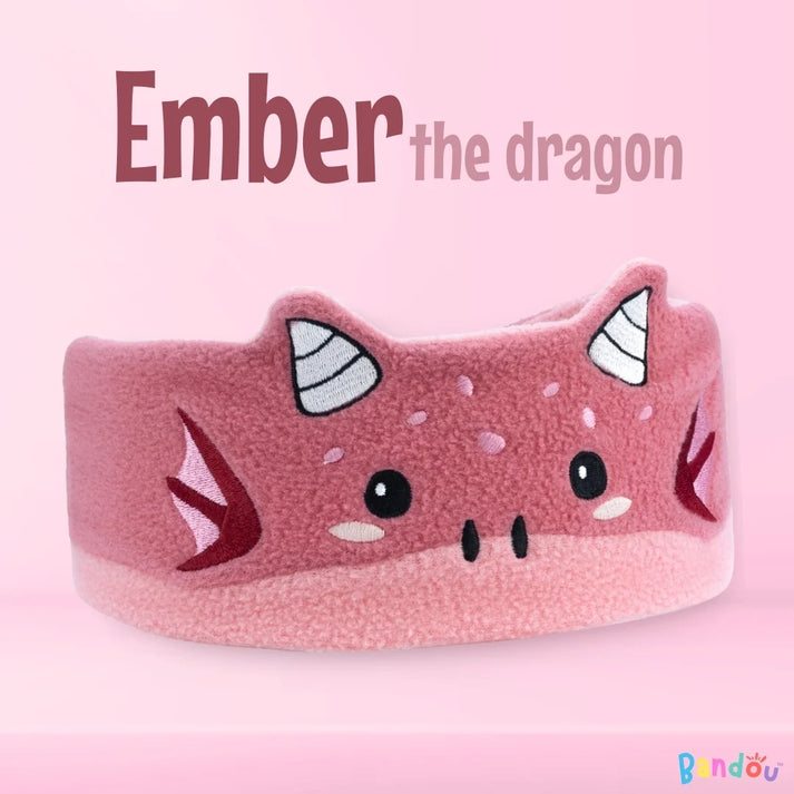 Pink dragon headband with cartoon eyes and horns, labeled 'Ember the dragon.'