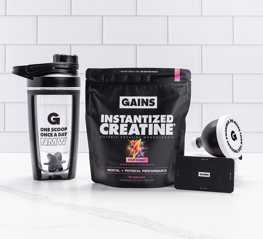 Creatine supplement bag, shaker bottle, funnel, and card against a tiled background.