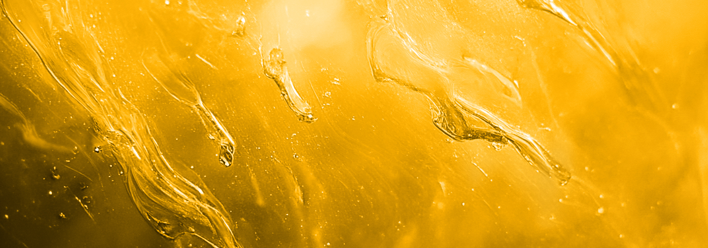 Abstract close-up of yellow liquid with swirling patterns.