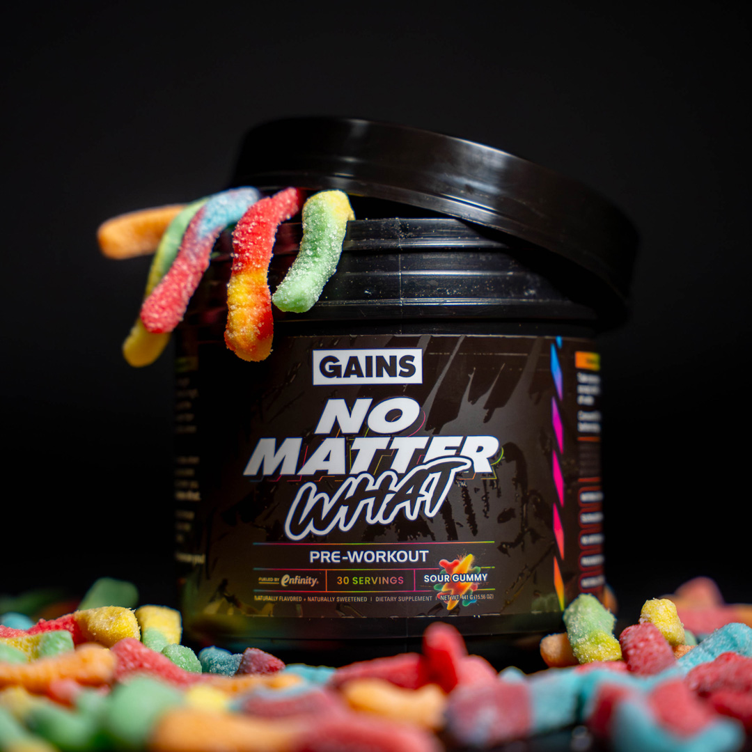 Pre-workout supplement container with colorful gummy candies spilling out.