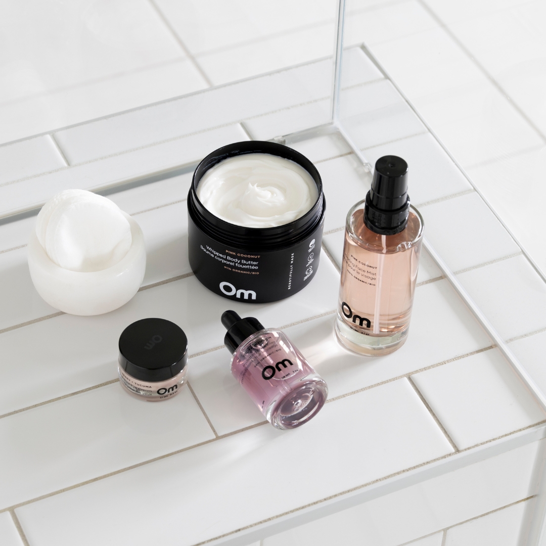 Assorted skincare products on a white tiled surface with a mirror reflection.