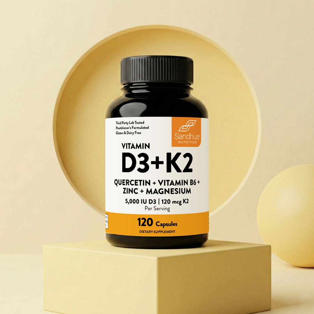 A bottle of Sandhus Nutrition Vitamin D3+K2 dietary supplement on a stylized yellow pedestal.