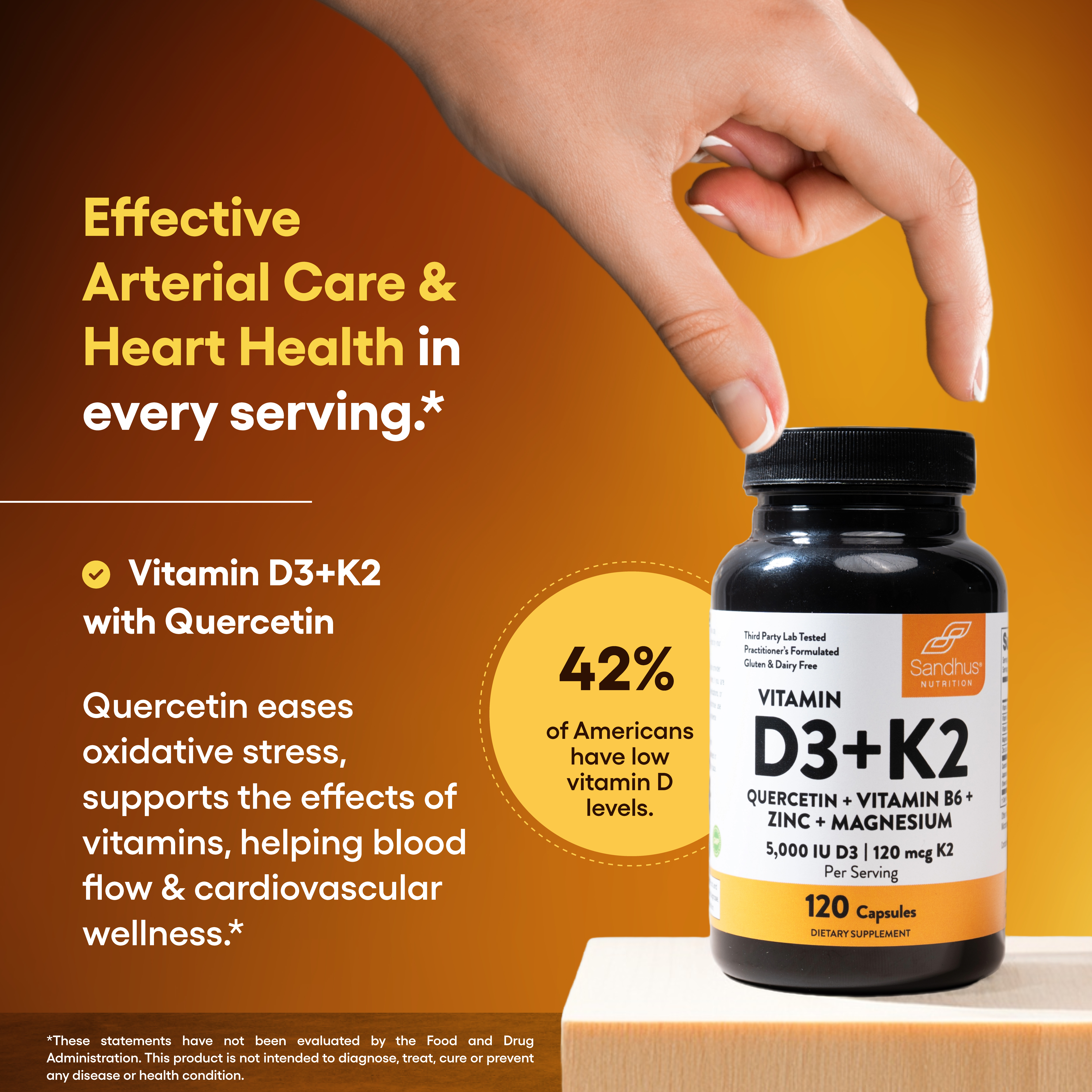 A hand reaching for the cap of a bottle of Sandhus Nutrition Vitamin D3+K2 supplements.
