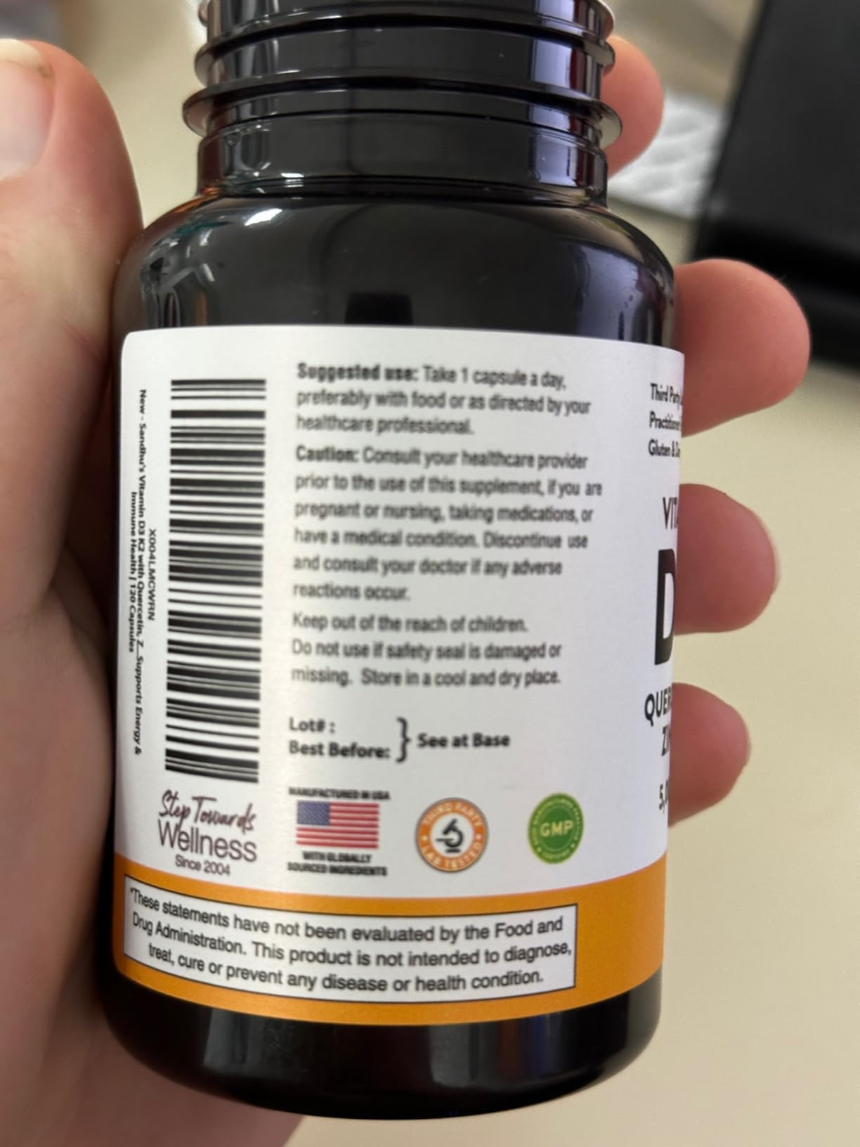 Close-up of a supplement bottle with label instructions and warnings.