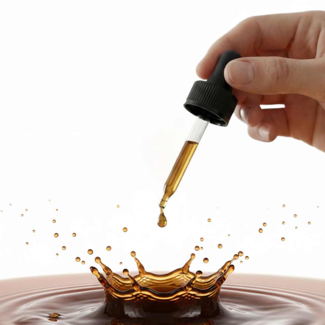 Hand holding a dropper above liquid with splash.