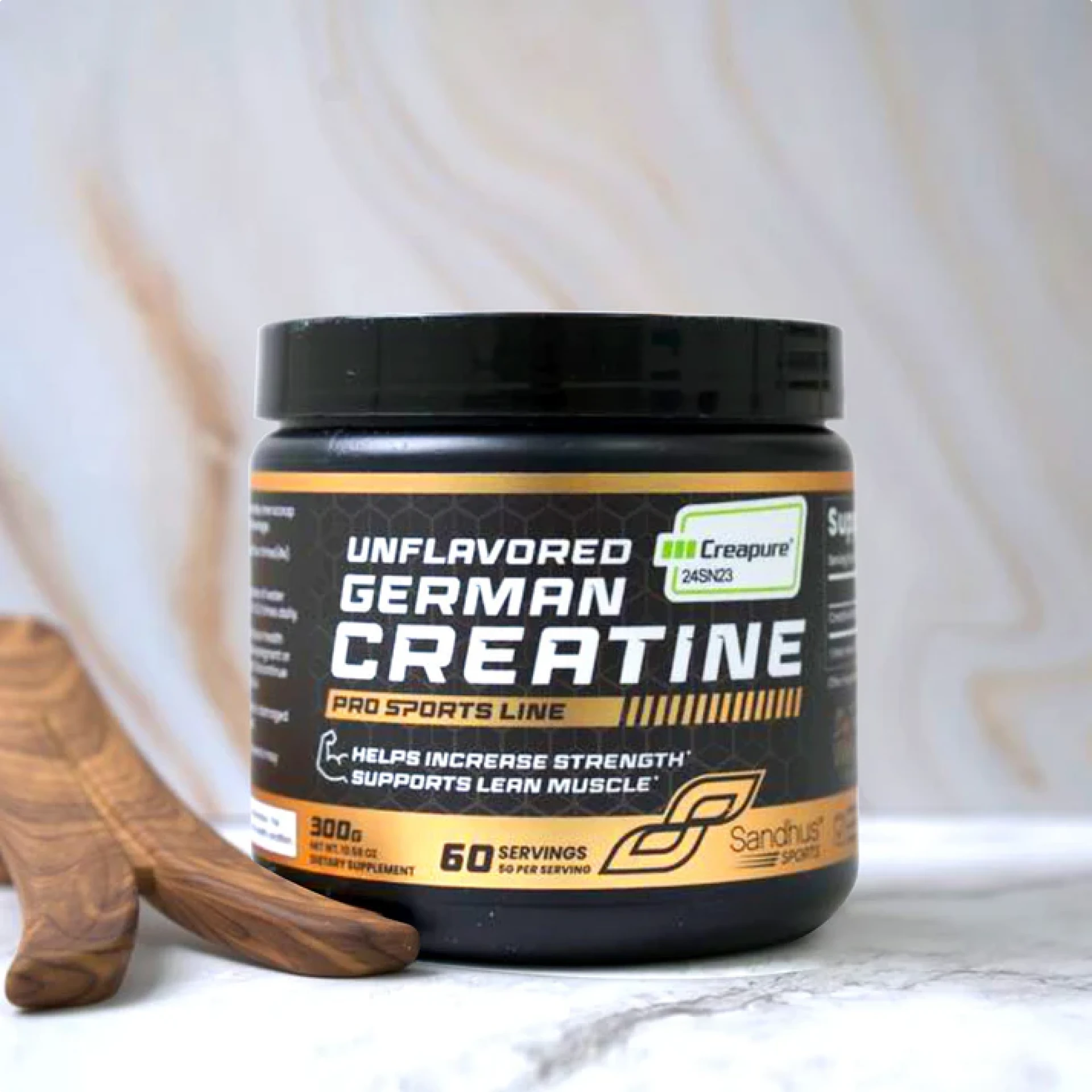Container of unflavored German creatine on a marble surface.