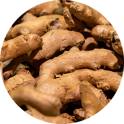A close-up, circular photo of a pile of fresh ginger root.