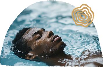 A person relaxing in a pool with eyes closed, partially submerged.