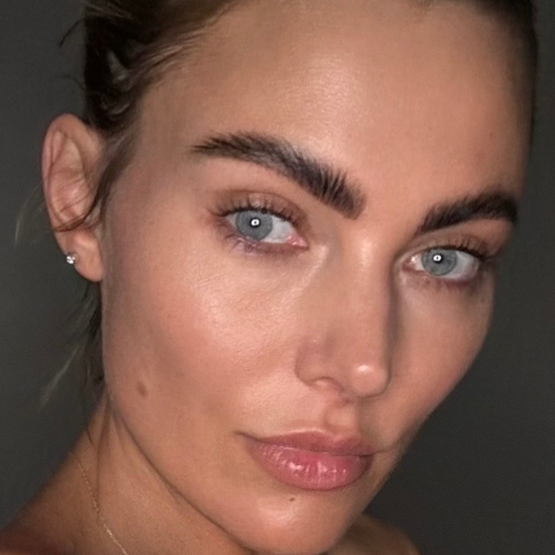 Close-up of a person with blue eyes and strong eyebrows.