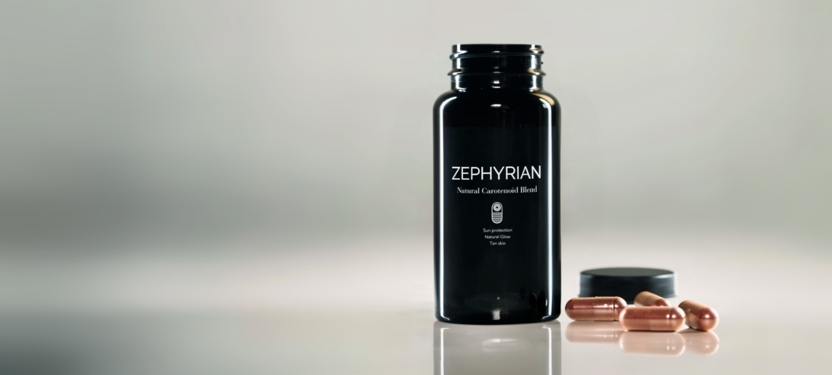 Black bottle labeled 'Zephyrian' with capsules and a lid on a reflective surface.