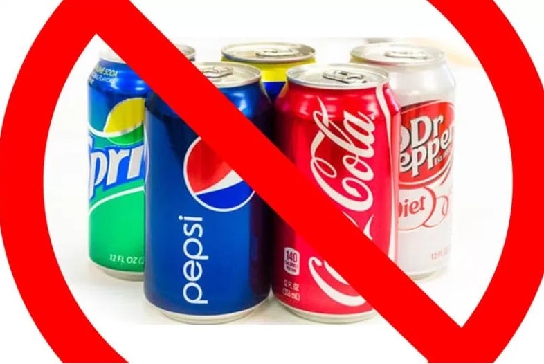 Assorted soda cans with a red prohibition symbol overlay.