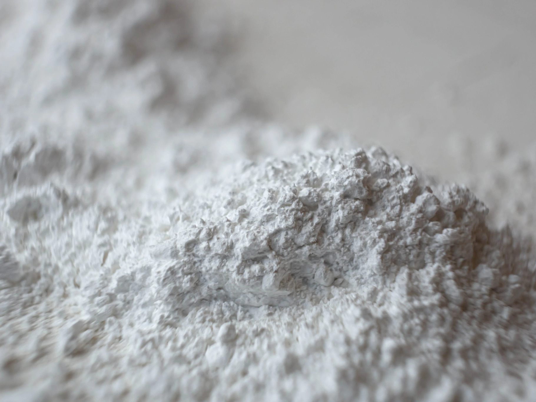 Close-up of a pile of white powder on a surface.