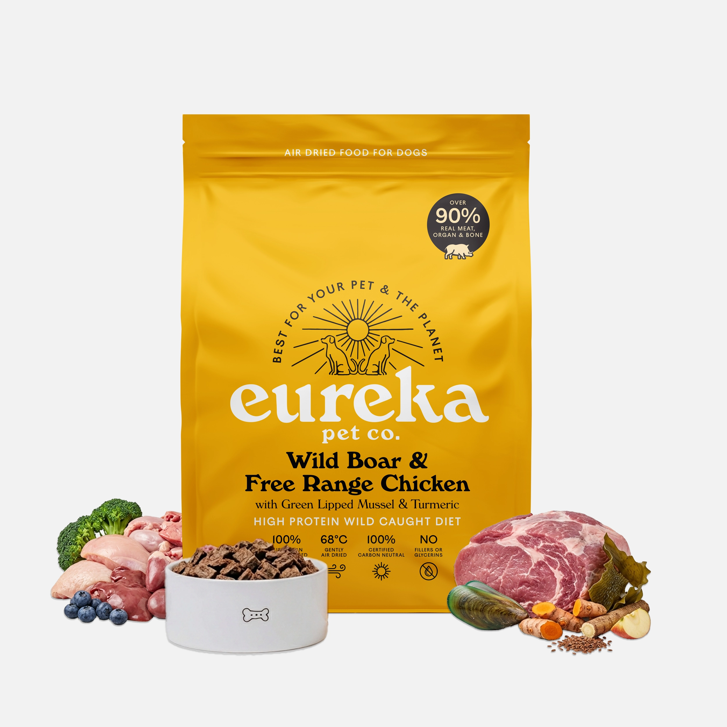 Eureka Pet Co. Wild Boar & Free Range Chicken air-dried dog food 1.8kg bag surrounded by fresh whole ingredients including wild boar, free range chicken, broccoli, blueberries and green lipped mussel with a bowl of food pieces