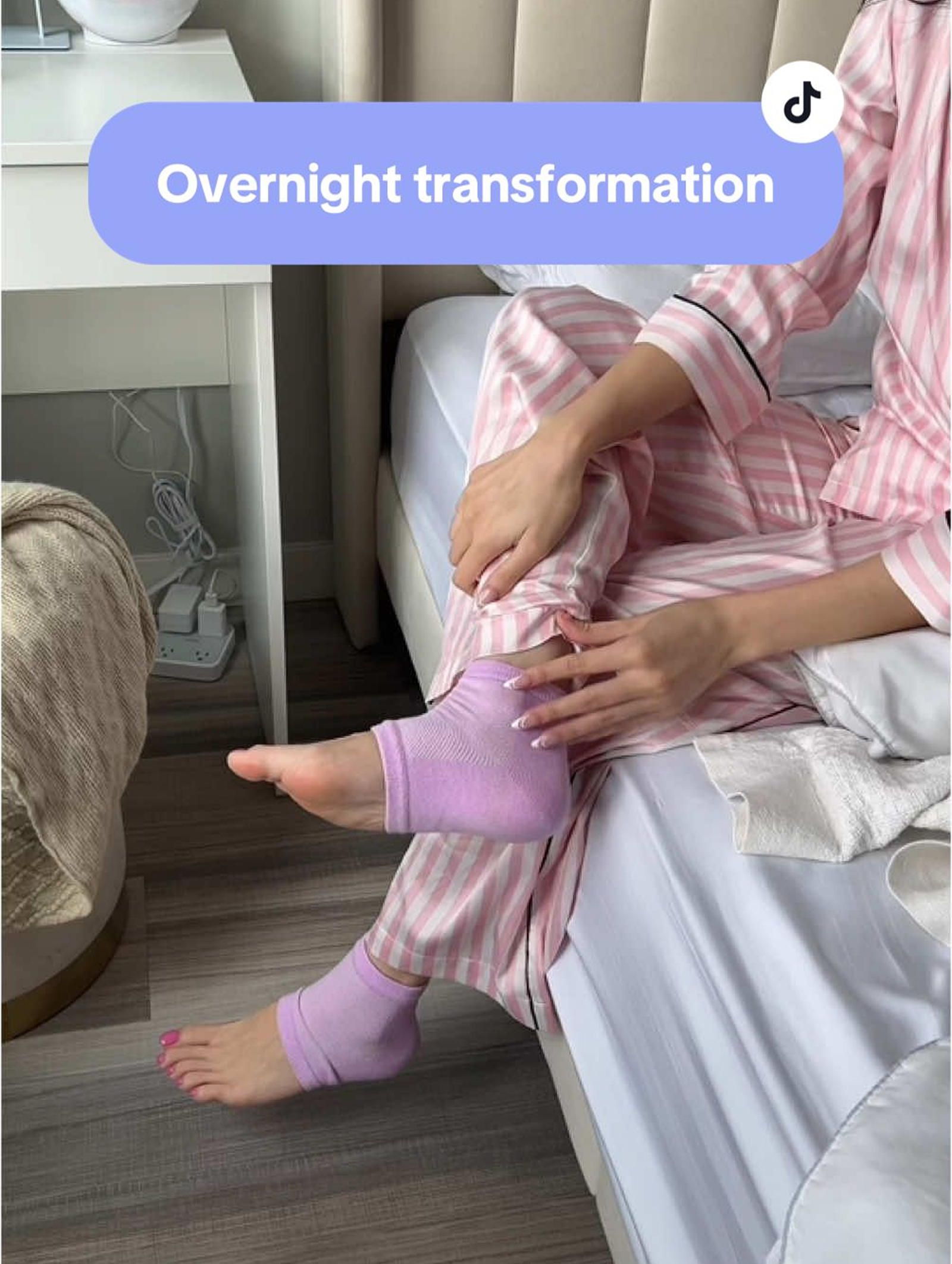 Person in pink striped pajamas sitting on bed, wearing purple ankle socks.