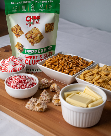 Assorted bowls of snacks and a Chunk Nibbles Peppermint Sweet & Salty Clusters package.