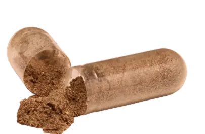Open capsule with brown powder spilling out.