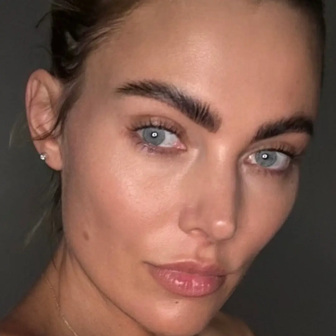 Close-up of a person looking at the camera, with strong eyebrow features.