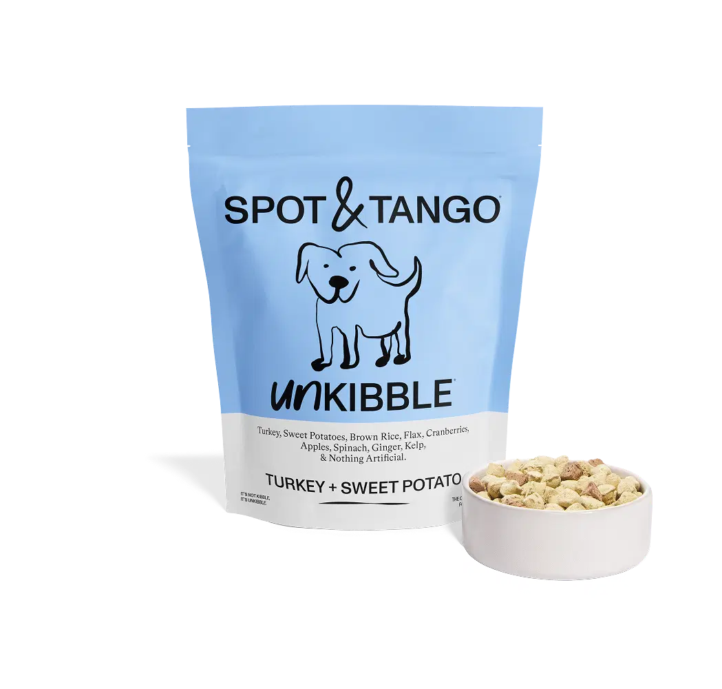 A bag of Spot & Tango Unkibble dog food, Turkey + Sweet Potato flavor, beside a full bowl.