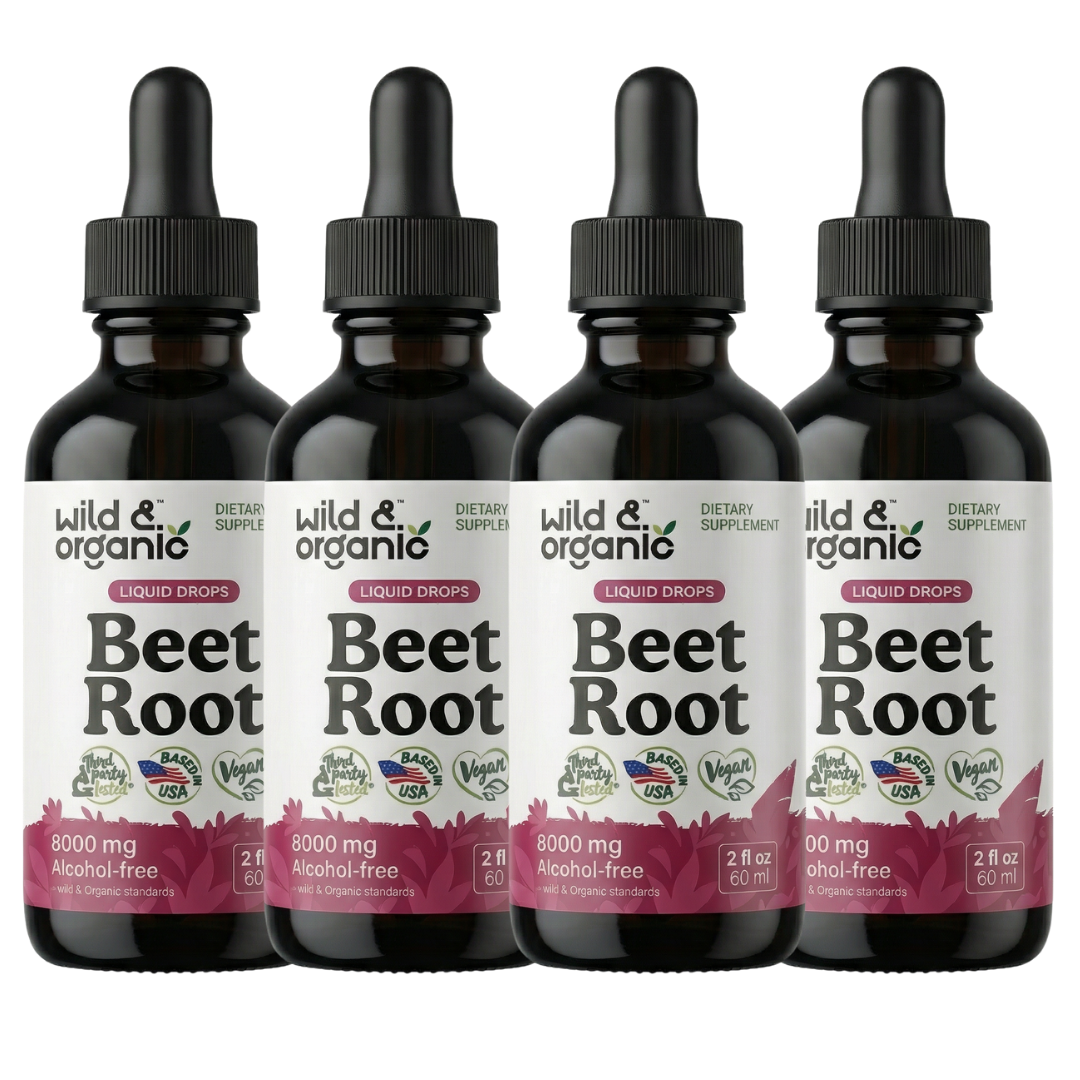 Four bottles of Wild & Organic Beet Root liquid drops dietary supplement against a black background.