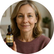 Person holding a dropper bottle labeled 'Wild Mullein' and smiling.
