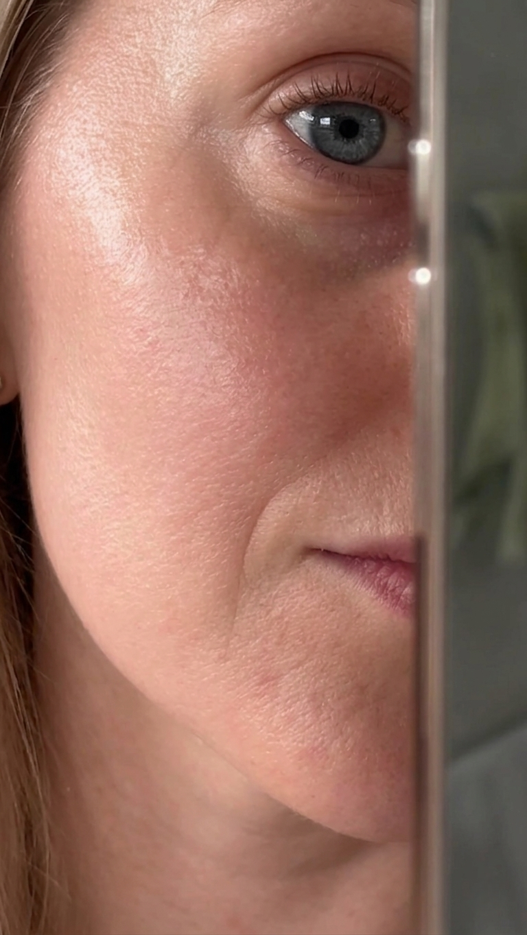 A close-up of a woman's face, showing her right eye, cheek, and a portion of her mouth.