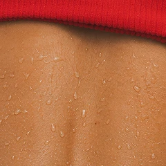 Close-up of a wet back with a red garment at the top.