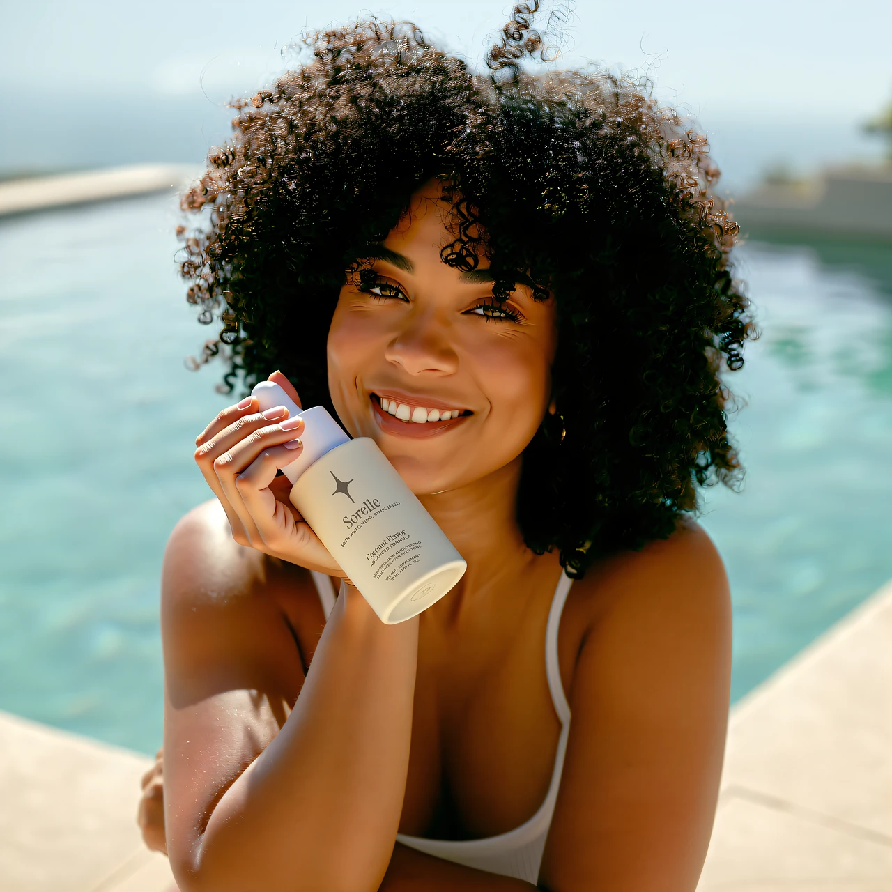 Smiling person holding a skincare product by a pool.