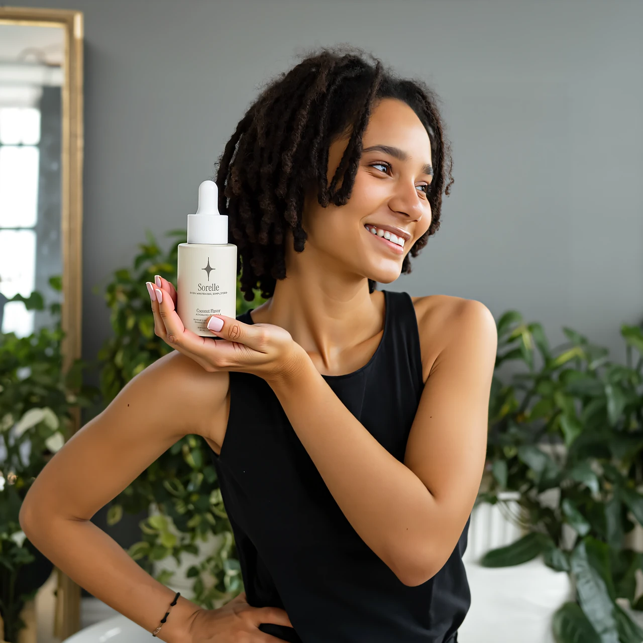 Person smiling, holding a dropper bottle, with plants in the background.