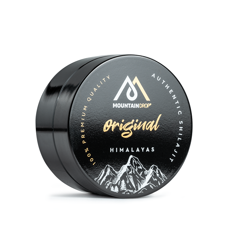 A round, black tin of Mountaindrop Original Himalayas shilajit sitting on a white surface.