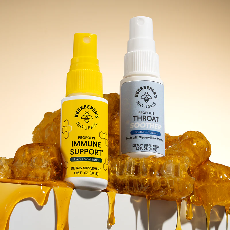 Two spray bottles labeled 'Immune Support' and 'Throat Soother' on honeycomb background.