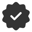 A dark gray, starburst-shaped badge with a white checkmark in the center.