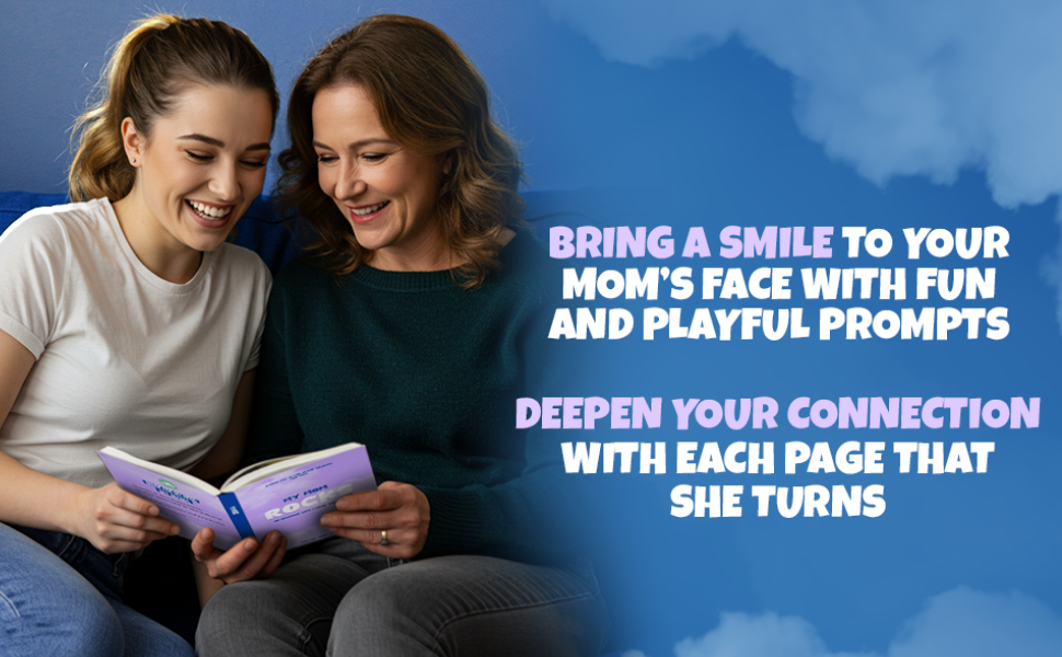 Two women smiling while reading a book together on a couch.