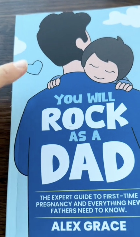 Book cover with a dad holding a child; text encourages new fathers.