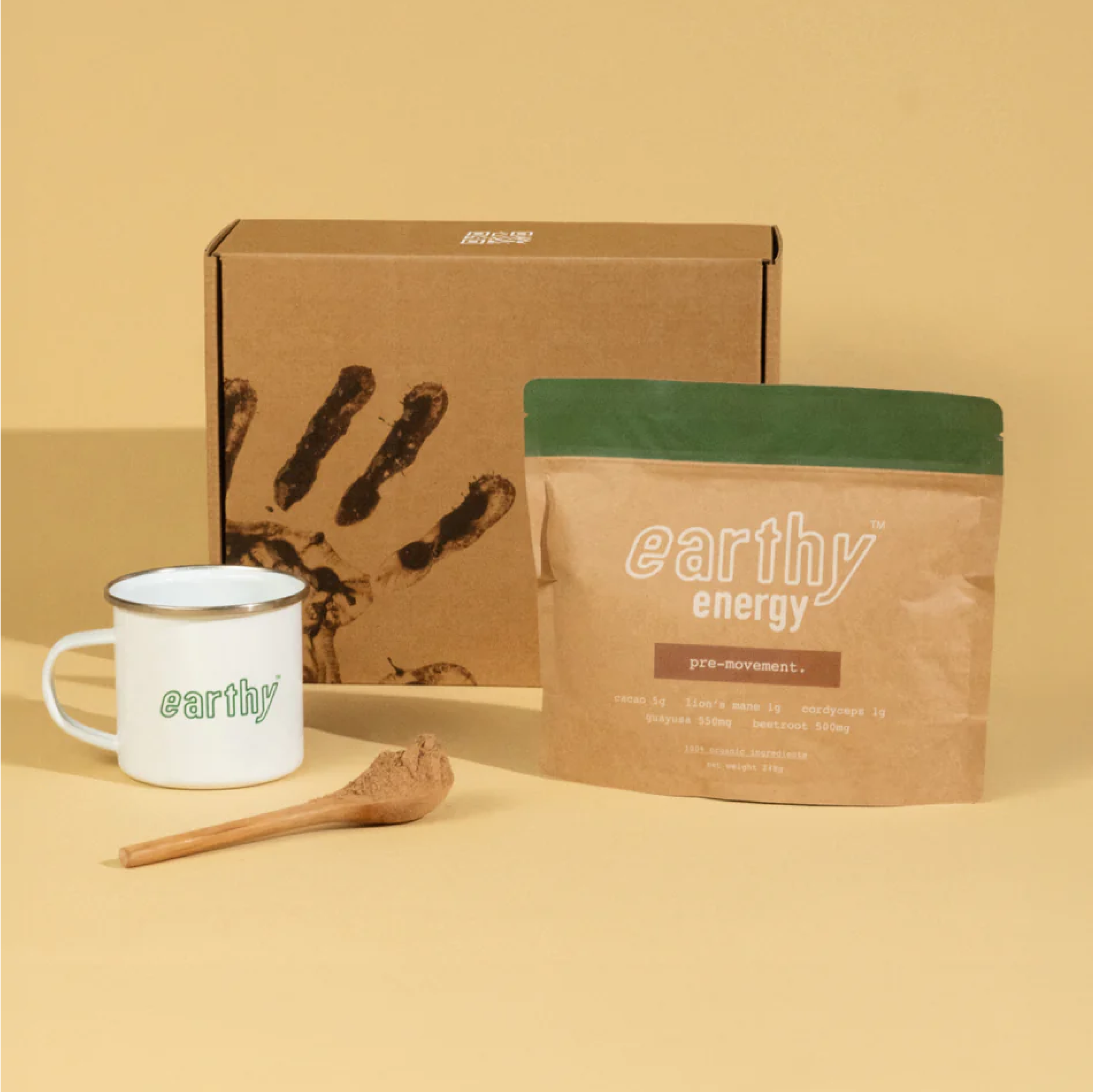 Earthy energy product packaging with a mug, spoon, and box on a beige background.