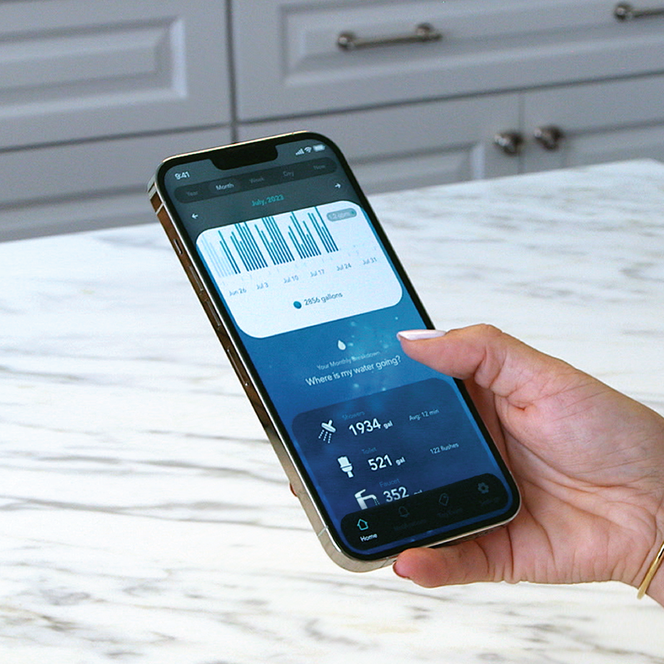 A person holding a smartphone displaying a water usage tracking app on the screen.