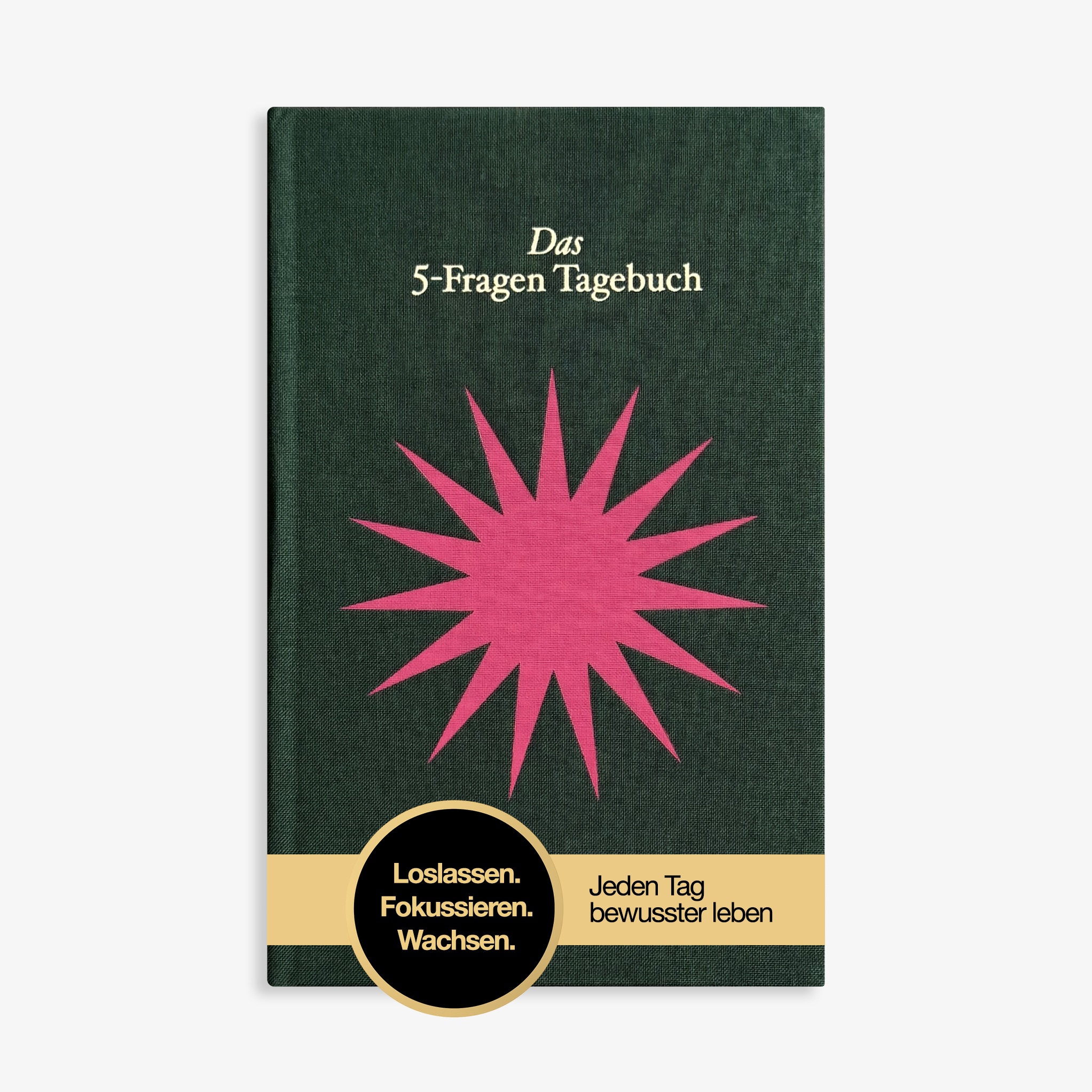 A dark green German journal titled 'Das 5-Fragen Tagebuch' with a pink starburst graphic on the cover.