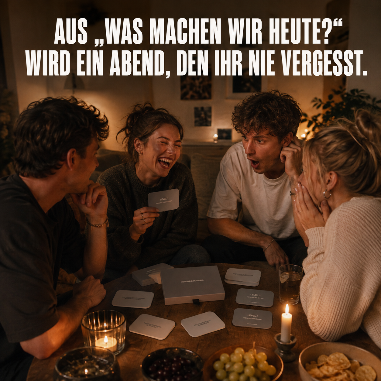 Four friends laughing and reacting with surprise while playing a card game at a candlelit table.