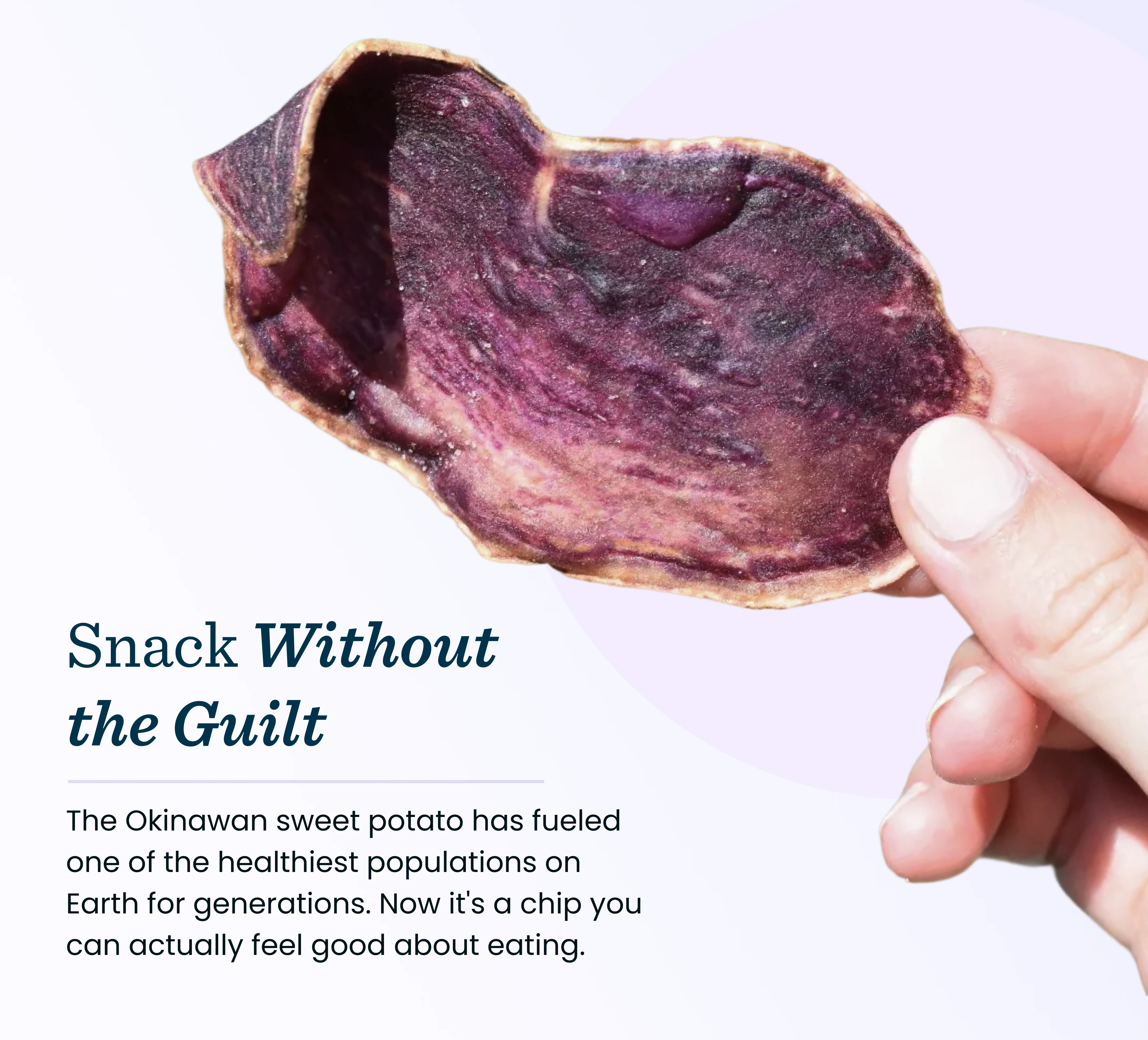 A hand holding a single, dark purple sweet potato chip against a light background.