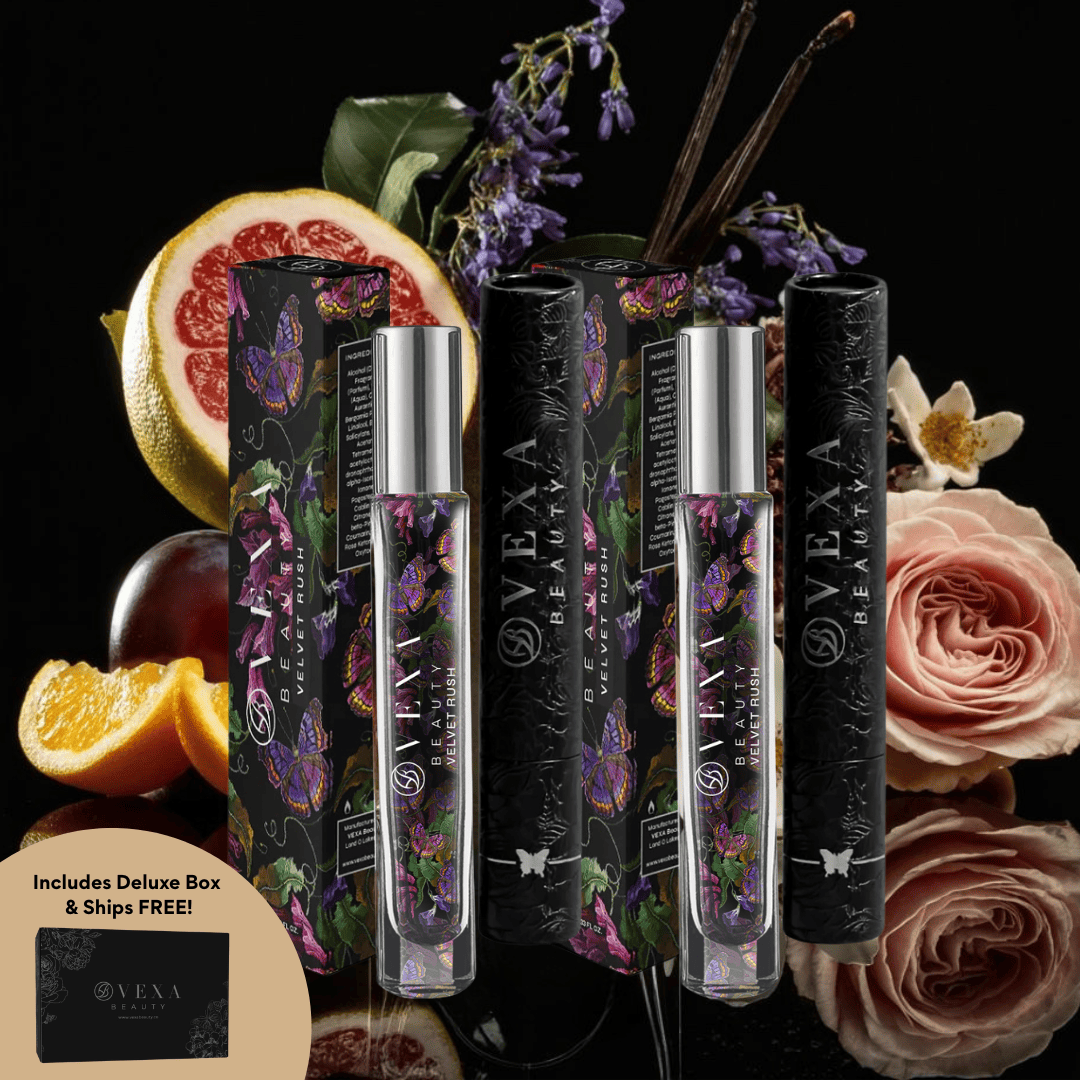 Perfume bottles with floral design, surrounded by fruits and flowers on a dark background.