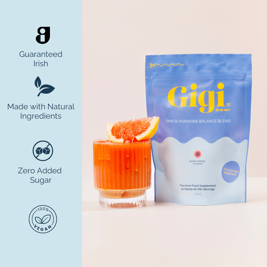 Blue package labeled 'Gigi' next to a blood orange drink with a slice on top.